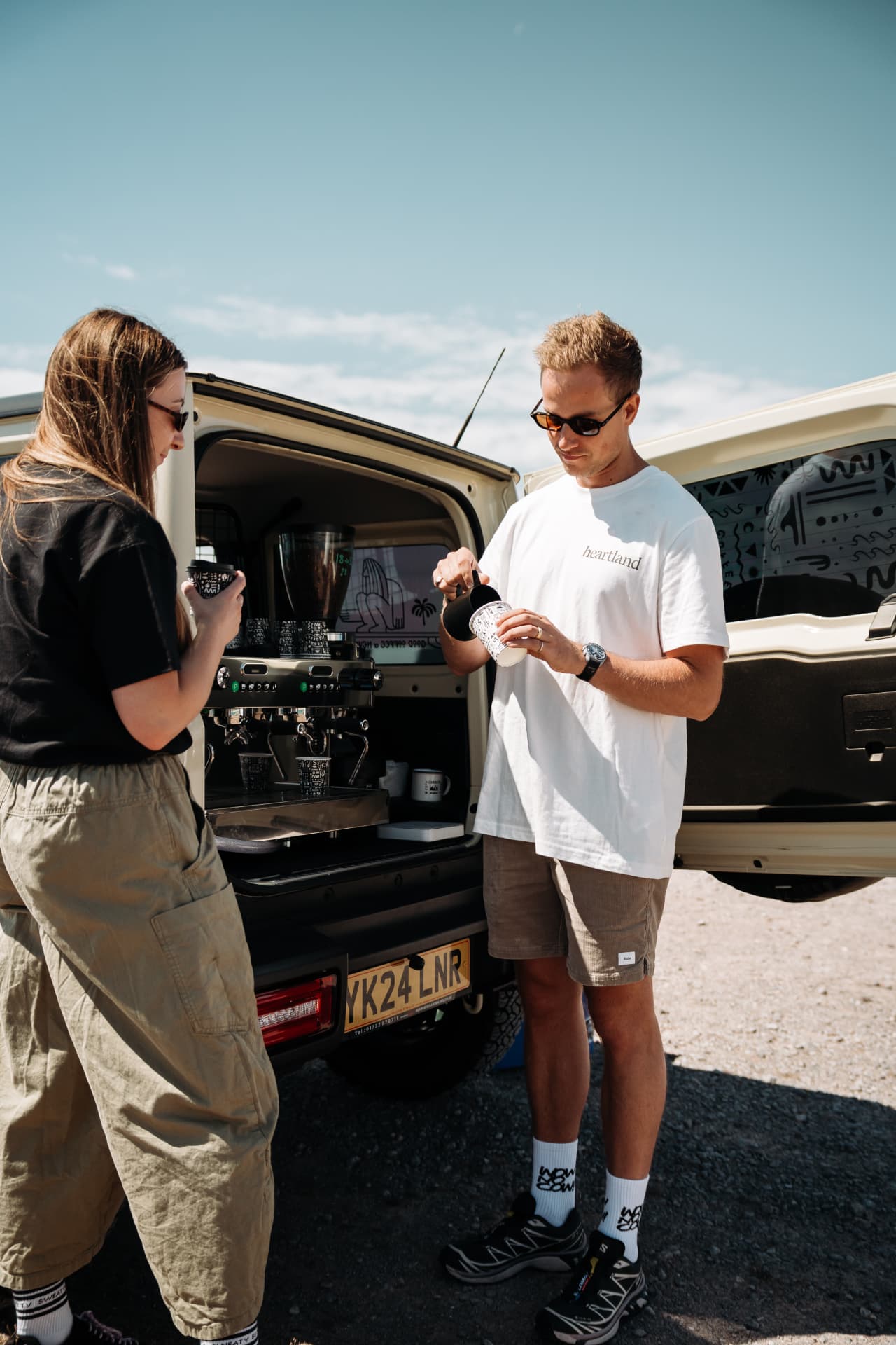 Pouring milk into a Corner Coffee cup by the truck